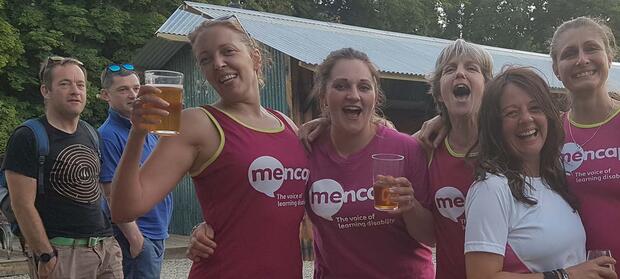 Group of people wearing Mencap tops, stood together outside.