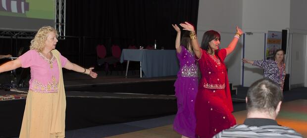 Group of people dancing on a stage.