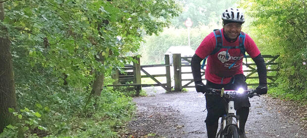 Man riding bike through woodland
