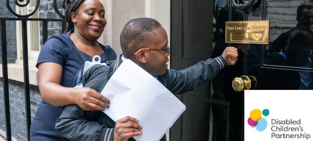 A mum and her son knocking on the door of Downing Street, handing in a petition.