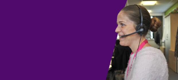 A woman with a phone headset on talking to a caller