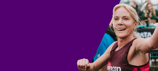 A blonde woman running in a Mencap vest and waving