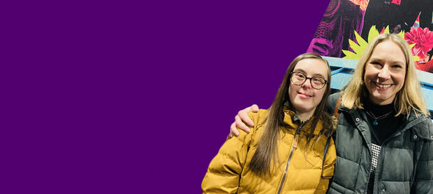 Two women standing smiling