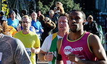 Group of runners running outside at marathon event