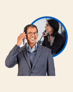 A man on the phone to a woman at a desk