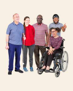 A group of four different people with different learning disabilities smiling. One has his thumbs up.