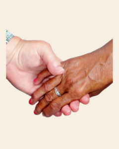 Two hands holding each other. One hand has a wedding ring
