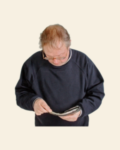 A man looking in his empty wallet for money