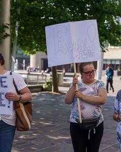 A group of activists holding signs campaigning in a street