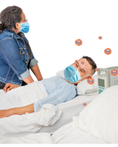 A woman visiting someone with coronavirus who is lying in a hospital bed