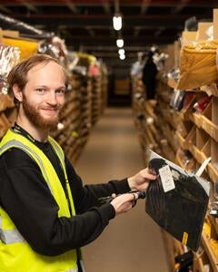 A man scanning an item in a warehouse. 