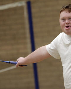 A man swinging a badminton raquette