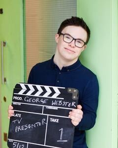 George holding a clapperboard