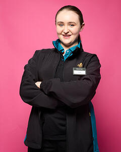 Emily wearing her uniform with a name badge