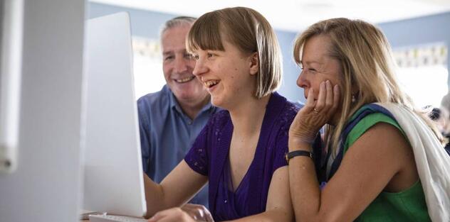 People looking at a computer
