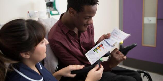 Nurse sharing an easy read form with a patient