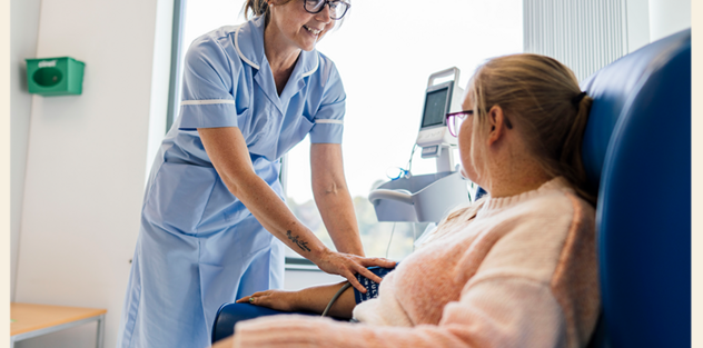A nurse is taking the blood pressure of a patient