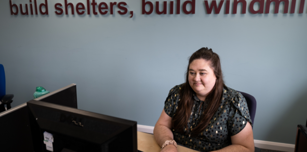 Helpline adviser on the phone whilst using a computer