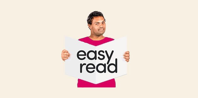 A man reading an Easy Read book